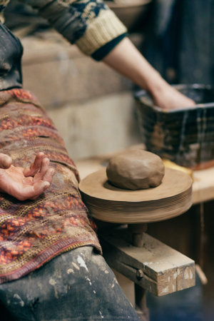 A potter makes a pot on a potters wheel, Master class on modeling of clay