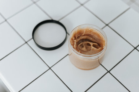 Jar with scrubs on square white tile backgroundの写真素材