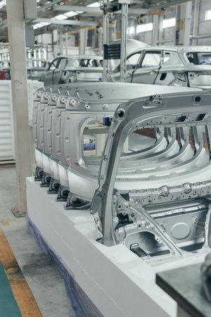 Batch of Unpainted Metal Car Hoods Ready for car Assembly in the Welding Shop of car Assembly Plant