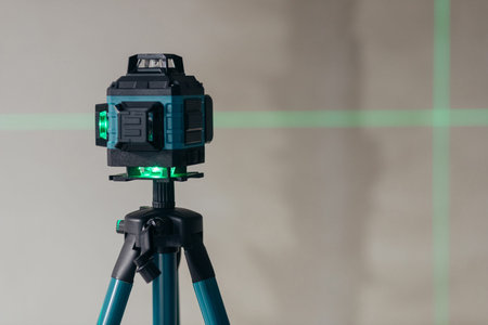 Laser Level Projecting Cross Lines On Wall. Precision Instrument For Alignment And Leveling.