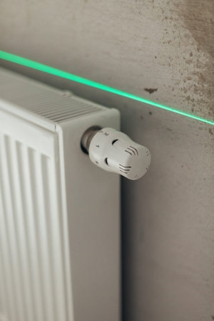 Smart Thermostat Valve On Radiator With Laser Level Alignment