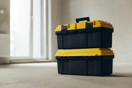 Two Stacked Tool Cases On Concrete Floor In Empty Room. Construction Equipment Storage During...