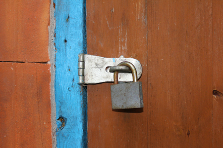 Old colored door closed on a padlockの写真素材
