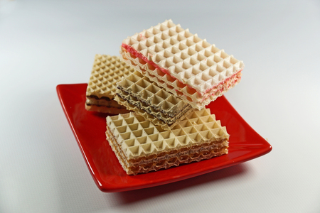 Different wafers, dessert on a red plate, closeupの写真素材