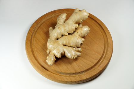 Whole root of ginger on a wooden boardの写真素材