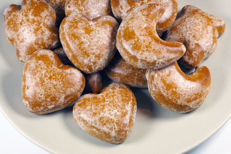 Iced gingerbread in the shape of hearts,, high-calorie dessert on a plateの写真素材