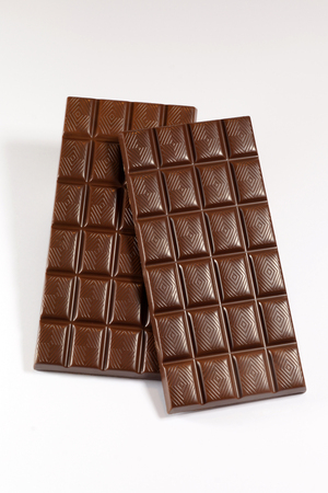 Two perfect milk chocolate bars on a white backgroundの写真素材