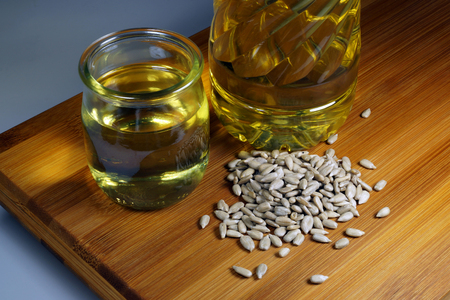 Shelled sunflower seeds, bottle and container with sunflower oil - horizontalの写真素材