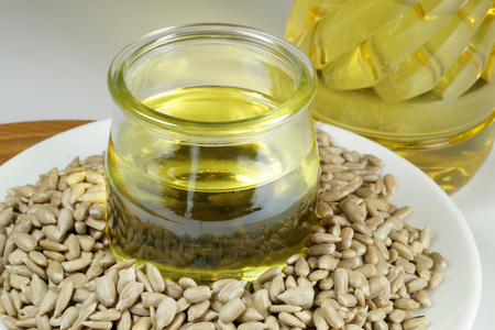 Shelled sunflower seeds, oil and a bottle with sunflower oilの写真素材
