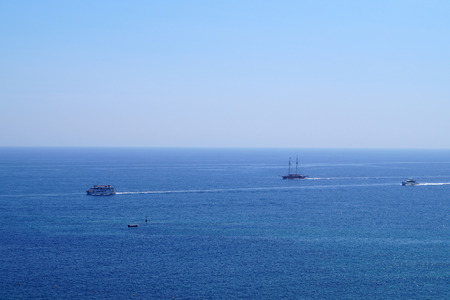Extensive view of the sea with sailing ships, blue sea, blue skyの写真素材