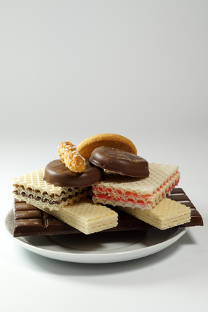 A plate full of various sweets, an unhealthy way of feeding - a vertical frameの写真素材