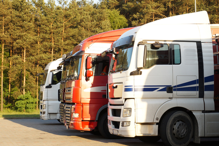 Trucks lit by the setting sun. Rest area (rest stop).の写真素材