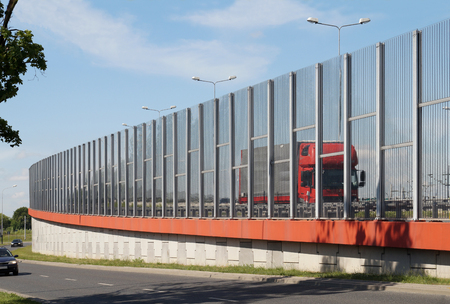 Street in the city built of transparent walls limiting the noise of passing cars.の写真素材