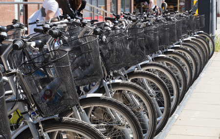 City bike station. Bicycles in equal row are waiting for usersの写真素材