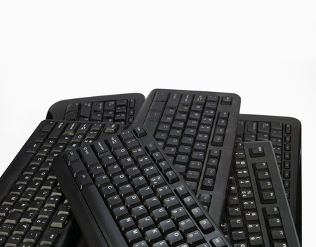 Horizontal frame filled with black computer keyboards. Computer equipment used for recycling.の写真素材