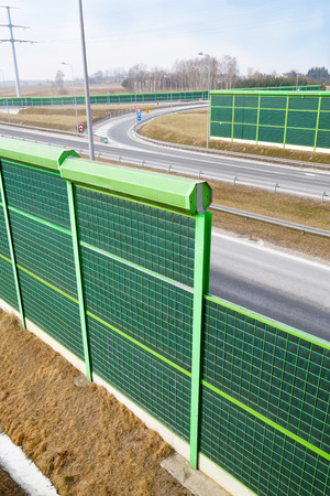 A noise barrier (also called a soundwall, noise wall, sound berm, sound barrier, or acoustical barrier) is an exterior structure designed to protection of people against noise.の写真素材