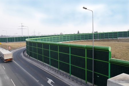 A noise barrier (also called a soundwall, noise wall, sound berm, sound barrier, or acoustical barrier) is an exterior structure designed to protection of people against noise.の写真素材