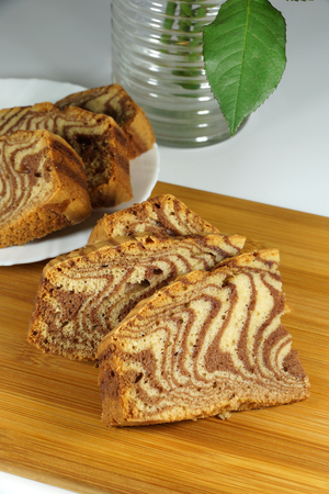 Zebra type cake, childhood memory, saucer, chopping board, bright backgroundの写真素材