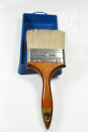 A large brush with natural bristles placed on a paint containerの写真素材