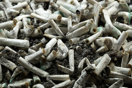 Heap of white cigarette butts, slim type, spilled ashの写真素材