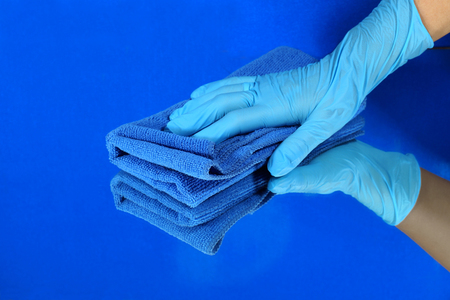 Cleaning action of the glass pane, blue gloves, microfibre clothの写真素材