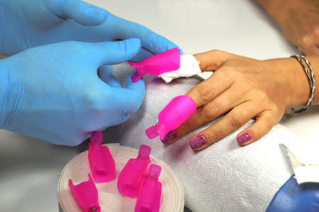 Attaching the clips to remove the hybrid nail polishの写真素材