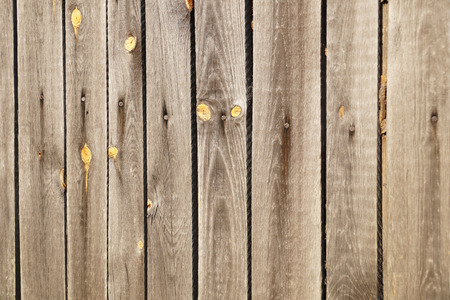 An old wooden wall made of boards nailed.の写真素材