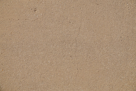 The surface of the concrete wall: slightly cracked, in warm beige color.の写真素材