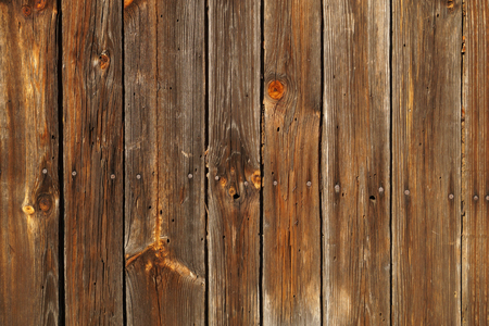 Background. A wall made of old planks connected by nails.の写真素材