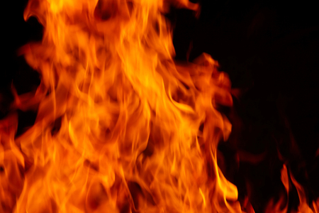 A background filled with defocused fire flames. High temperature and danger.の写真素材