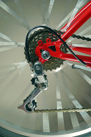 The rear wheel of the red bicycle with the derailleur, the wheel rotate.の写真素材