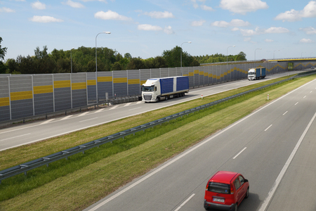 Vehicles moving in a tunnel with panels suppressing the sound of car engines. Highway in the summer sun.の写真素材