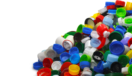 A heap of recyclable caps from plastic bottles. Secondary raw material.の写真素材