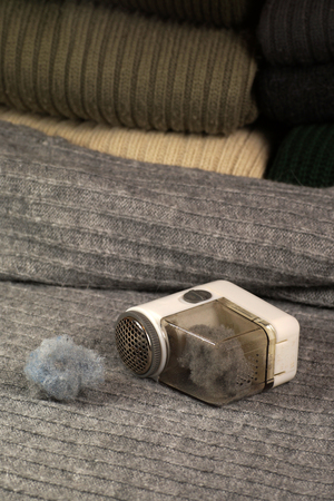 A few sweaters prepared for removing lint (pilling) and a device for removing them.の写真素材