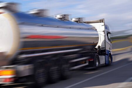 Fast motorway crossing. A shiny tanker truck.の写真素材