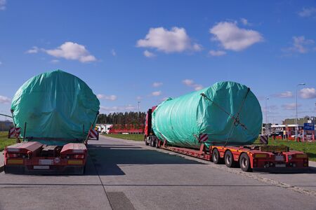 A truck with a special semi-trailer for transporting oversized loads.  Oversize Load or exceptional convoy.の写真素材