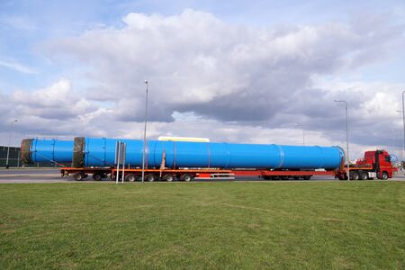 A truck with a special semi-trailer for transporting oversized loads. Oversize Load or exceptional convoy. の写真素材