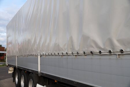 Truck transport. View of the tarpaulin covering the semi-trailer of the truck. の写真素材