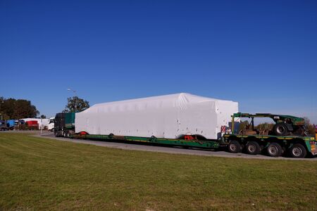 Break in transport. Trucks with specialized semi-trailers adapted for transporting oversized goods.の写真素材