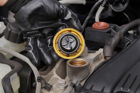 Oil fill cap unscrewed. Oil change. Car repair shop.の写真素材