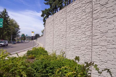 Protection of residents against noise generated by car traffic. Concrete acoustic barriers decorated with a structural pattern of stones. の写真素材