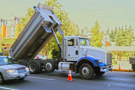 A city in the USA. Truck (dumper) in urban traffic. 