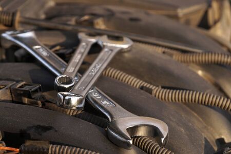 Wrenches for repair lying in the engine compartment. Car repair workshop.の写真素材