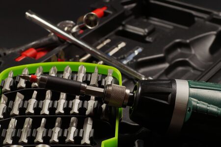 Cordless with bit holder in the foreground. Screwdriver bit set.の写真素材