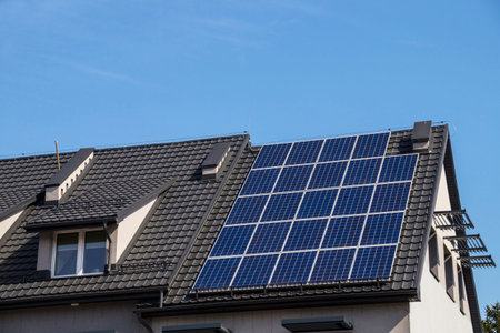 Installed solar panels. The roof of the building made of metal tiles.