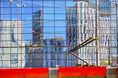 The facade of a modern building. Reflection in the facade of another building.の写真素材