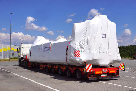 Oversize load or exceptional convoy. A truck with a special semi-trailer for transporting oversized loads. Very long vehicle.の写真素材