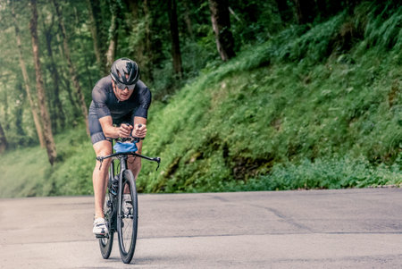 Man participating in triathlon with bicycle in mountain area