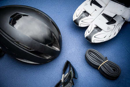 Triathlon items on blue background with red shoesの写真素材