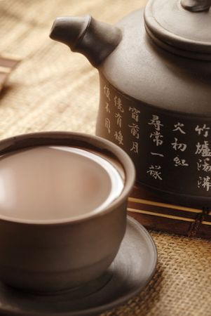 Tea in demitasse and teapot with hieroglyphicの写真素材